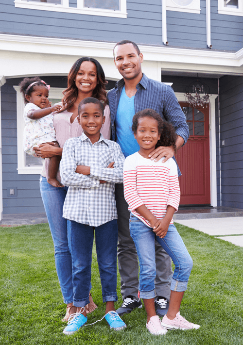 a happy family in front of their home