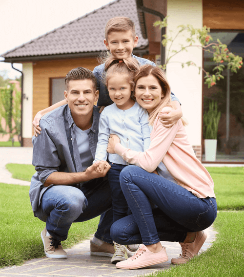 a happy family in front of their home